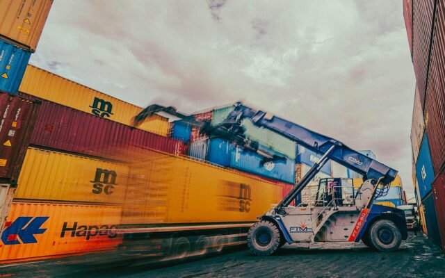 Container Yard with Crane Moving Shipping Containers