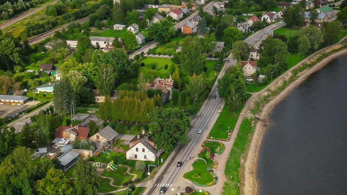 Aerial View of Town Alongside River on Cloudy Day