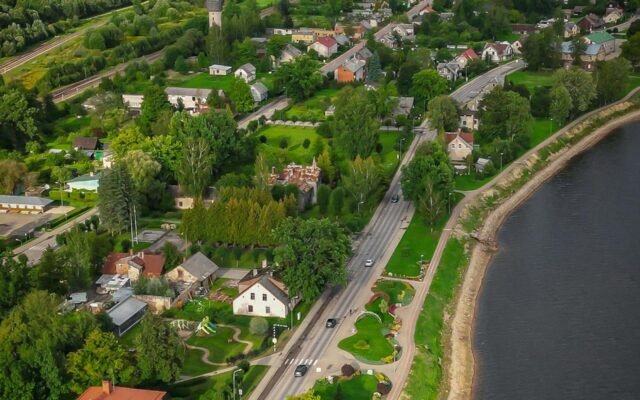 Aerial View of Town Alongside River on Cloudy Day